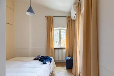 a bedroom with a bed and a window at iFlat Trastevere Stylish 4 Bedroom Penthouse in Rome