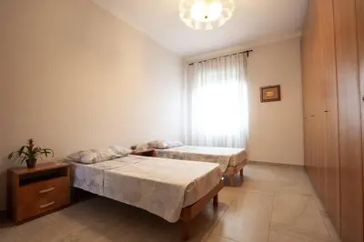a bedroom with two beds and a window at Ninkasi Bed and Beer San Giovanni Via La Spezia 74 Roma in Rome