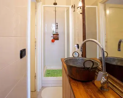 a bathroom with a sink and a shower at Ninkasi Bed and Beer San Giovanni Via La Spezia 74 Roma in Rome