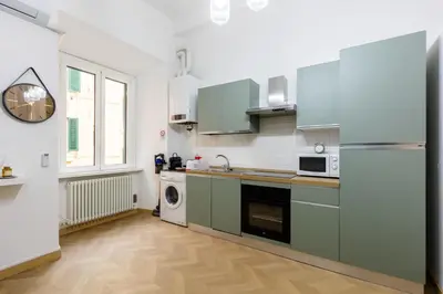 a kitchen with a refrigerator and a dishwasher at Colosseum Boutique apartment in Rome