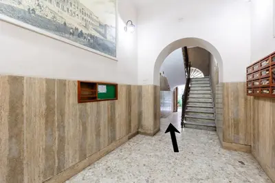 a staircase in a building with an arrow pointing to the floor at Colosseum Boutique apartment in Rome