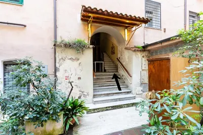a person standing on the stairs of a building at Colosseum Boutique apartment in Rome
