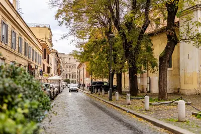 a cobblestone street with a car driving down a street at Colosseum Boutique apartment in Rome