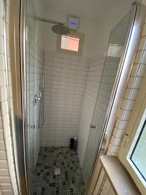 a bathroom with a shower with a tiled floor at Fanfulla Bilocale Pigneto in Rome