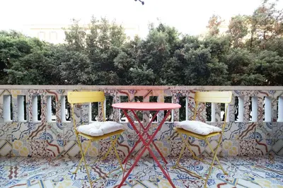 a pink table and two chairs on a patio at Casa Cipradino in Rome