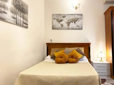 a bedroom with a bed with yellow pillows on it at Ariana Apartments in Rome