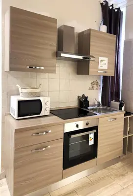 a kitchen with a microwave oven and a stove at Ariana Apartments in Rome