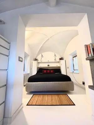 a bedroom with a bed in a white room at Navona Luxury Suite Apartment by NDP rent in Rome