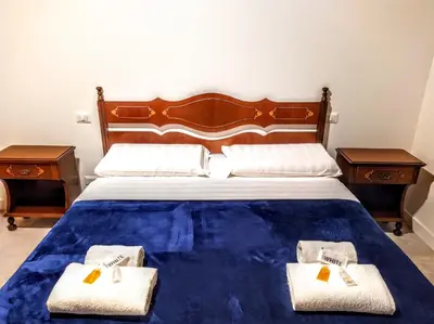 a bedroom with a large bed with two night stands at Loryand near Stadio Olimpico in Rome