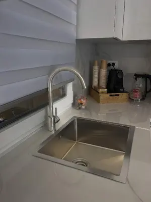 a kitchen counter with a sink in a kitchen at Alissa Suite in Rome