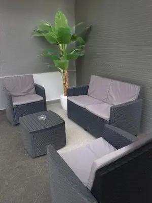 a patio with two chairs and a couch and a table at Alissa Suite in Rome