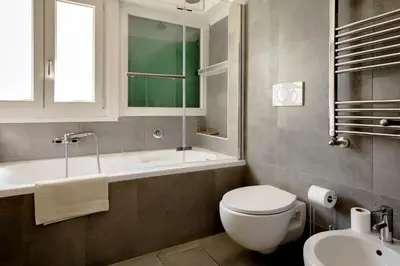 a bathroom with a toilet and a sink and a tub at Vatican View in Rome
