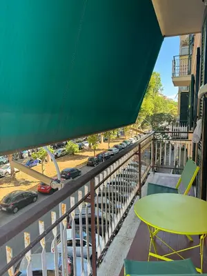 a balcony with a table and a view of a street at Dora Apartment in Rome