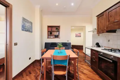 a kitchen and dining room with a table and chairs at Centro Storico a 15' - Cata Apartment Roma in Rome