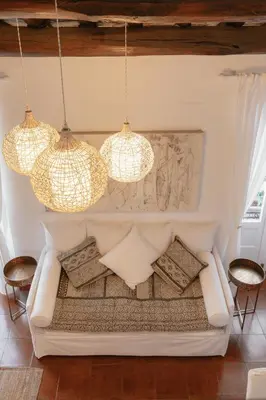a living room with a couch and three lights at Piazza Navona Historic Luxury Apartment in Rome