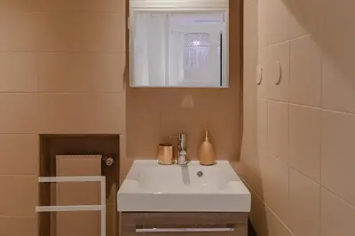 a bathroom with a white sink and a mirror at Piazza Navona Historic Luxury Apartment in Rome