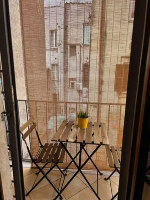 a table with a potted plant on top of a window at Trastevere Moro apartment in Rome