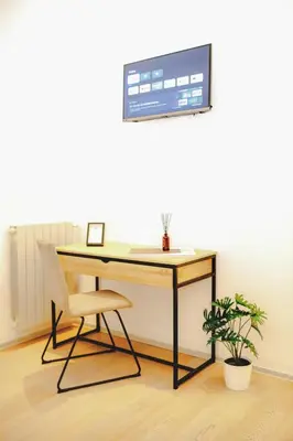 a desk with a chair and a computer monitor on a wall at Magikrooms Kandy in Rome