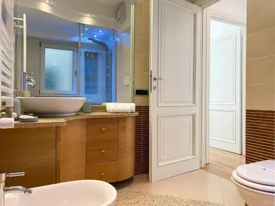 a bathroom with a sink and a toilet and a mirror at Be Close - Porta Portese Appartamento con terrazza in Rome