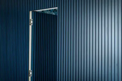 a blue wall with a silver pole in front of it at Circolo degli Scipioni in Rome