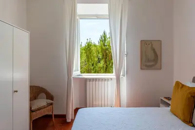 a bedroom with a bed and a large window at Casa Augusto - Charme Holidays in Rome