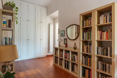 a room with book shelves filled with books at Casa Augusto - Charme Holidays in Rome