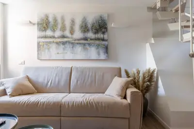 a living room with a couch and a painting on the wall at MauveSweetRhome 3 in Rome