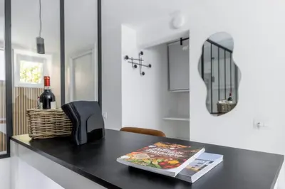 a kitchen counter with a book and a bottle of wine at MauveSweetRhome 1 in Rome