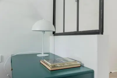 a glass table with a lamp and books on it at MauveSweetRhome 4 in Rome