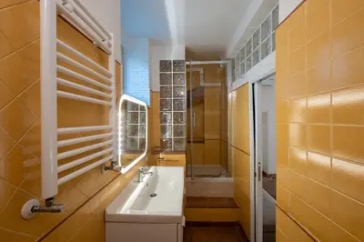 a kitchen with a table and a white refrigerator at Milvio Urban House in Rome