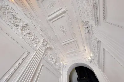 an ornate ceiling in a room with a doorway at Porta Flaminia Suites in Rome