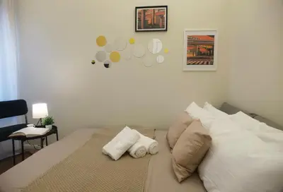 a bedroom with a bed with two pillows on it at Metro Lodi Apartment in Rome