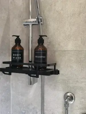 a soap dispenser with two bottles on a bathroom sink at Metro Lodi Apartment in Rome