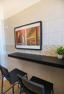 a mirror on a wall with two chairs at Metro Lodi Apartment in Rome