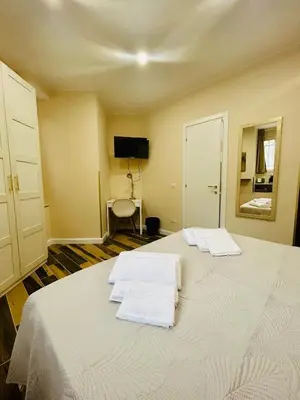 a bedroom with two white towels on a bed at SD Vatican Rooms in Rome