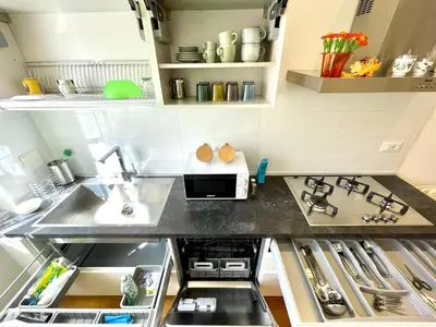 a small kitchen with a sink and a stove at Vittoria's home in Rome