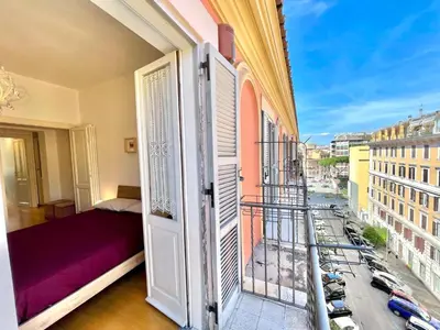 a room with a balcony with a view of a city at Vittoria's home in Rome