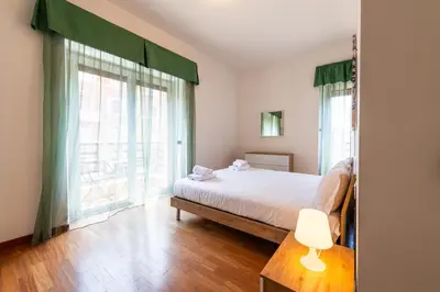 a bedroom with a bed and a large window at Re di Roma Lodge in Rome