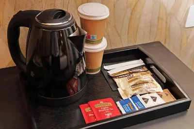 a black tray with a coffee pot and coffee cups at Habito Suites in Rome