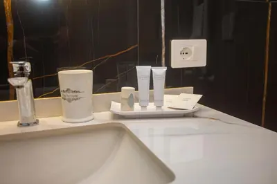a bathroom counter with a sink and a mirror at Vespucci Palace Roma in Rome