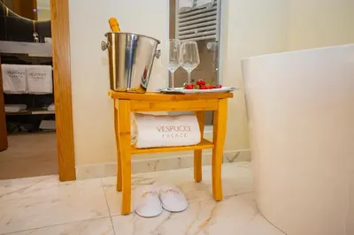a small table next to a white refrigerator at Vespucci Palace Roma in Rome
