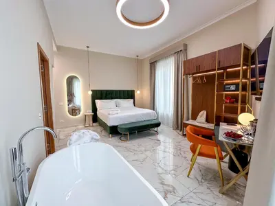 a bathroom with a bed and a tub in a room at Vespucci Palace Roma in Rome