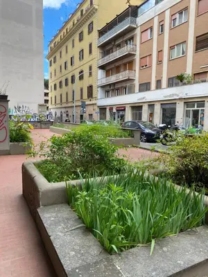 a park with plants and buildings in a city at Saluzzo Apartment in Rome