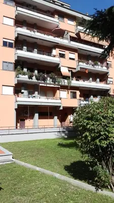 a large apartment building with plants on the balconies at Saluzzo Apartment in Rome