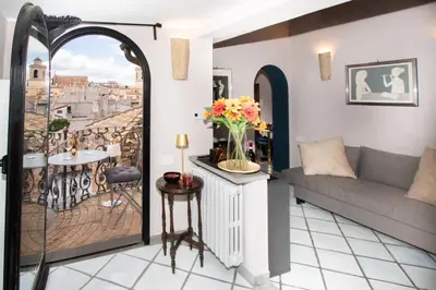 a living room with a couch and a balcony at Alessio Luxury House Roma Pantheon-Piazza Navona in Rome