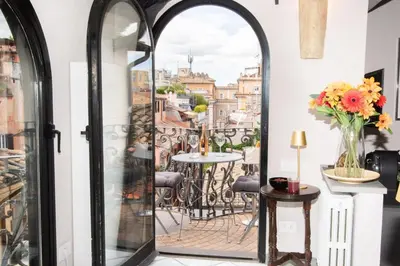 a room with a balcony with a table and chairs at Alessio Luxury House Roma Pantheon-Piazza Navona in Rome