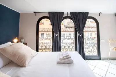 a bedroom with a bed and a large window at Alessio Luxury House Roma Pantheon-Piazza Navona in Rome