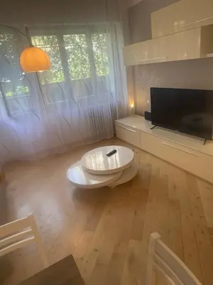 a living room with a tv and a white table at Carpegna Vatican House in Rome