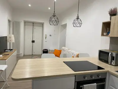 a kitchen and living room with a counter top at St Peter Family Stay in Rome