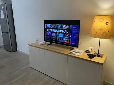 a flat screen tv on a counter with a lamp at St Peter Family Stay in Rome